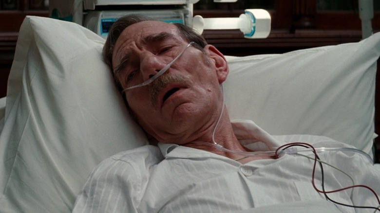 Pete Postlethwaite in a hospital bed