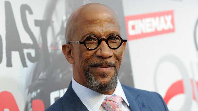 Reg E. Cathey wears glasses