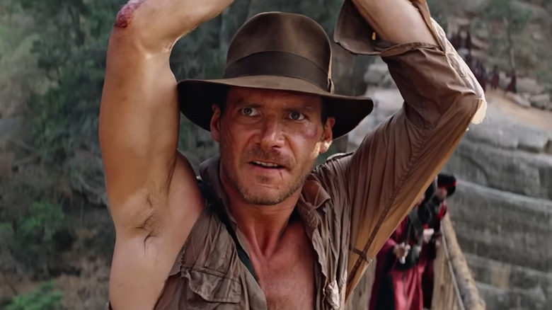 Indiana Jones arms raised