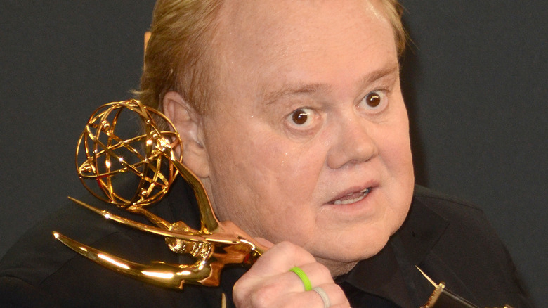 Louie Anderson holding Emmy Award