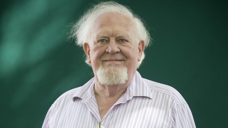 Joss Ackland smiling green background