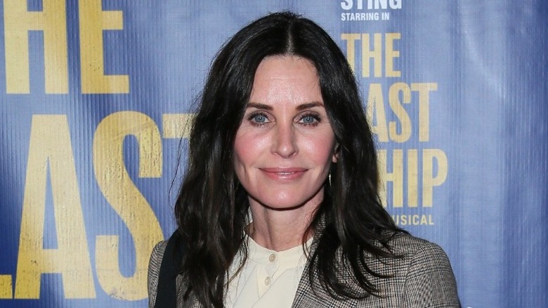 Courteney Cox smiling on red carpet at premiere 