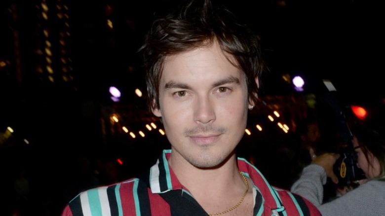 Tyler Blackburn in striped shirt