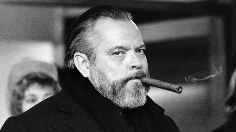 Orson Welles smokes a cigar