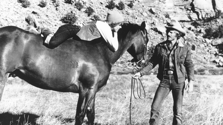 https://www.looper.com/img/gallery/actors-who-adopted-animals-from-the-set/robert-redford-rides-home-on-horseback-1635764046.jpg