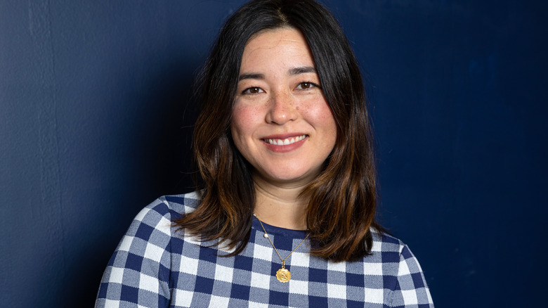 Maya Erskine smiling blue background