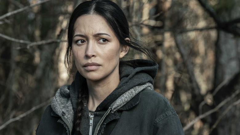 Rosita looking concerned in woods