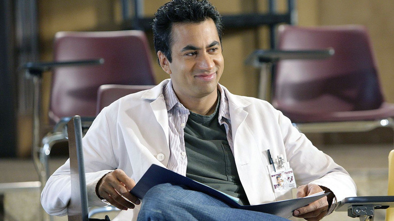 Kutner sitting holding folder