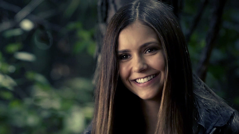 Elena smiling in woods