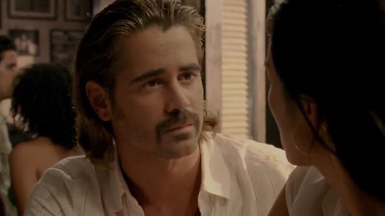 Colin Farrell sitting in a restaurant in Miami Vice