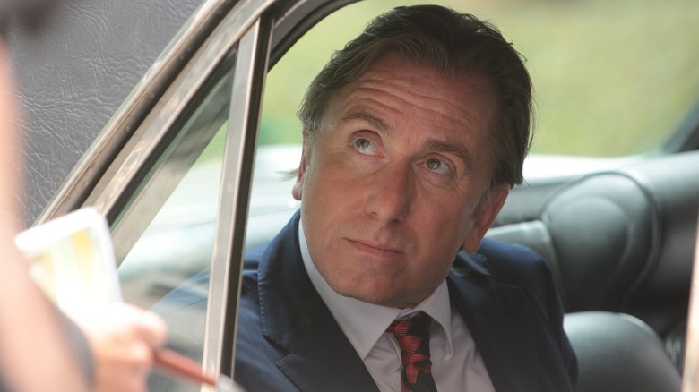 Tim Roth sitting in a car