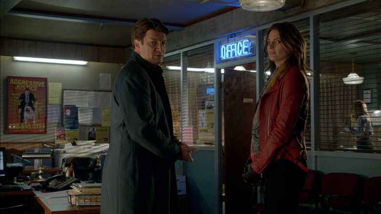 Richard Castle (Nathan Fillion) with Kate Beckett (Stana Katic) in a bail bonds office on Castle