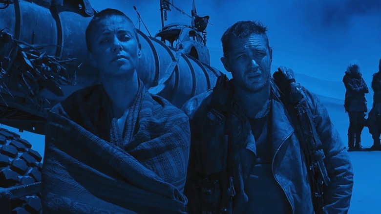 Furiosa (Charlize Theron) with Max (Tom Hardy) at night in Mad Max: Fury Road