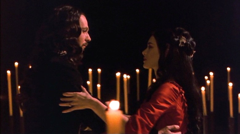 Count Dracula (Gary Oldman) holding Mina Harker (Winona Ryder) amidst candles in Bram Stoker's Dracula