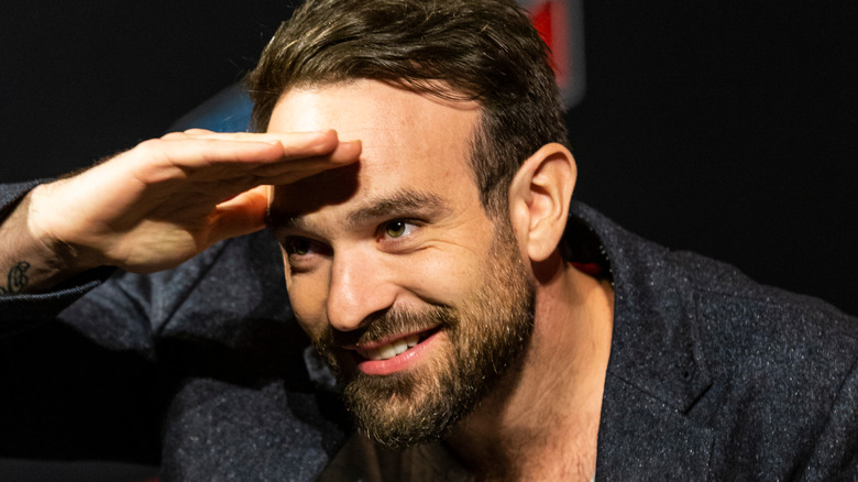 Charlie Cox playfully poses on stage