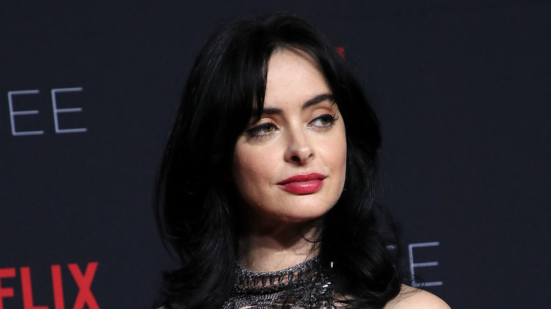 Krysten Ritter smirks at camera