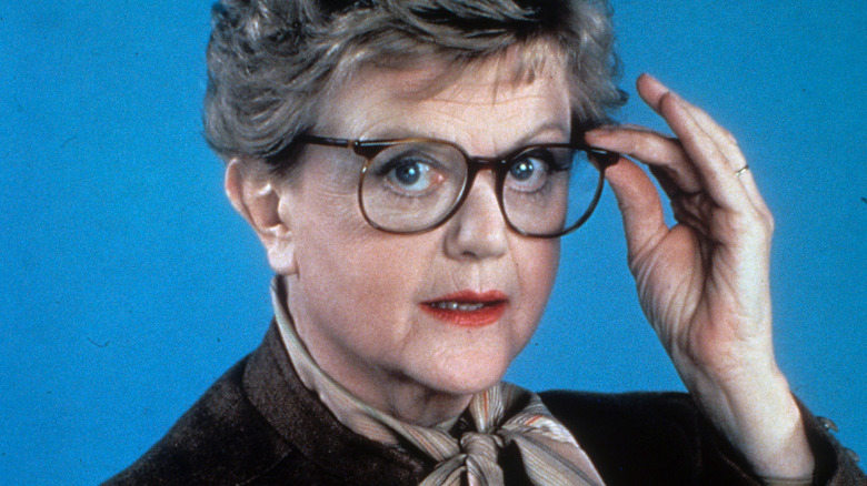 Angela Lansbury holds her glasses