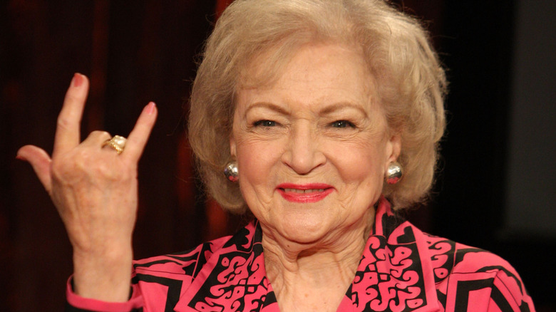 Betty White holds up devil horns