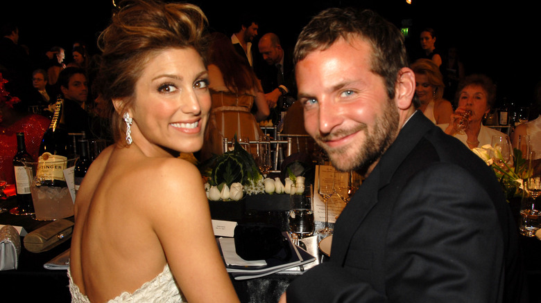 Jennifer Esposito and Bradley Cooper turn to face the camera at an awards show