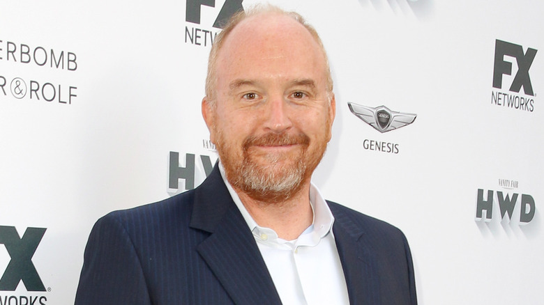 Louis C.K. smiling in blue suit