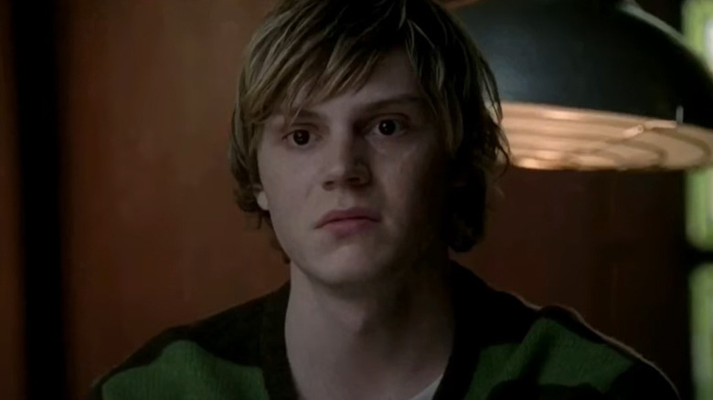 Tate Langdon wearing green sweater