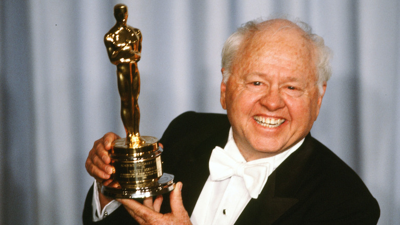 Mickey Rooney holds up an honorary Oscar in 1983