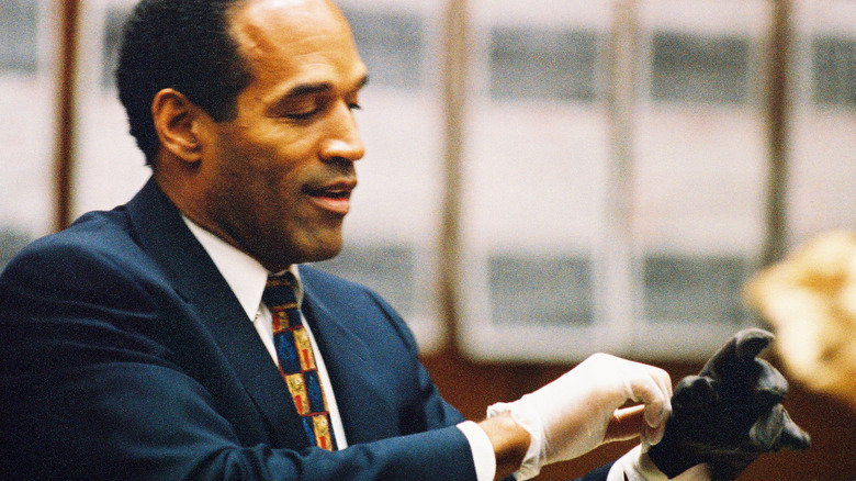 O.J. Simpson tries on glove