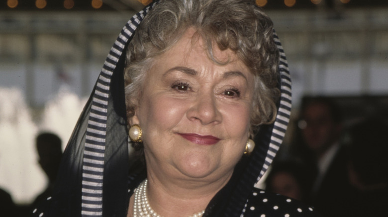 Joan Plowright, wearing a black-and-white hooded outfit, in 1997