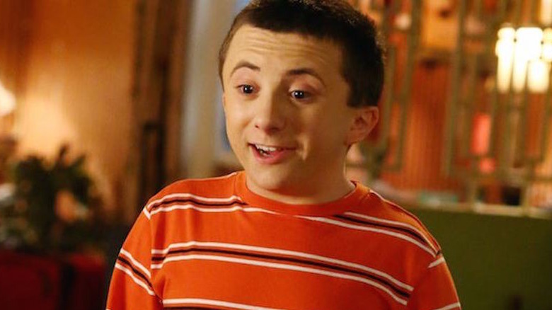 Atticus Shaffer talking and smiling