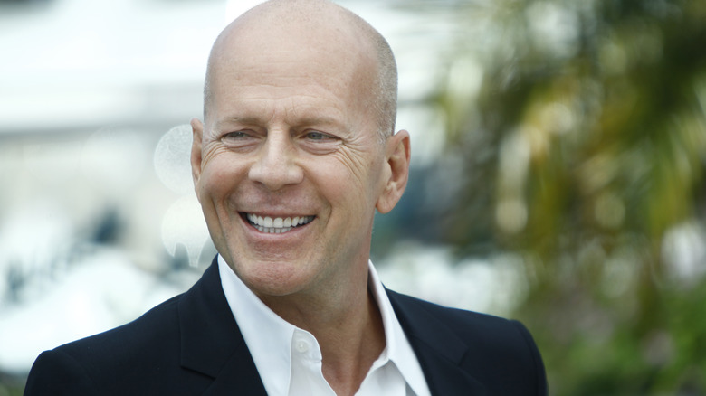 Bruce Willis smiling wearing suit