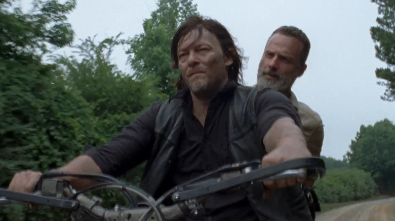 Daryl and Rick riding on motorcycle