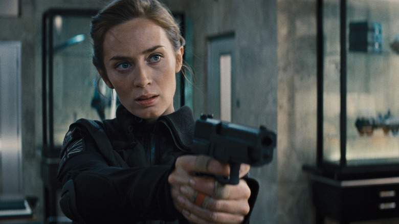 Sergeant Rita Vrataski wields a gun in "Edge of Tomorrow" (2014)