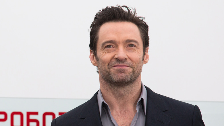 Hugh Jackman smiling on red carpet