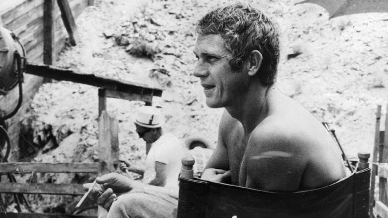 Steve McQueen sitting in chair