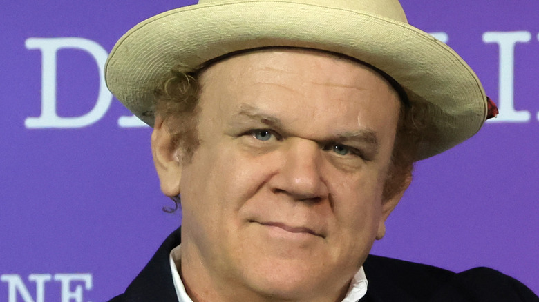 John C. Reilly solemn in hat