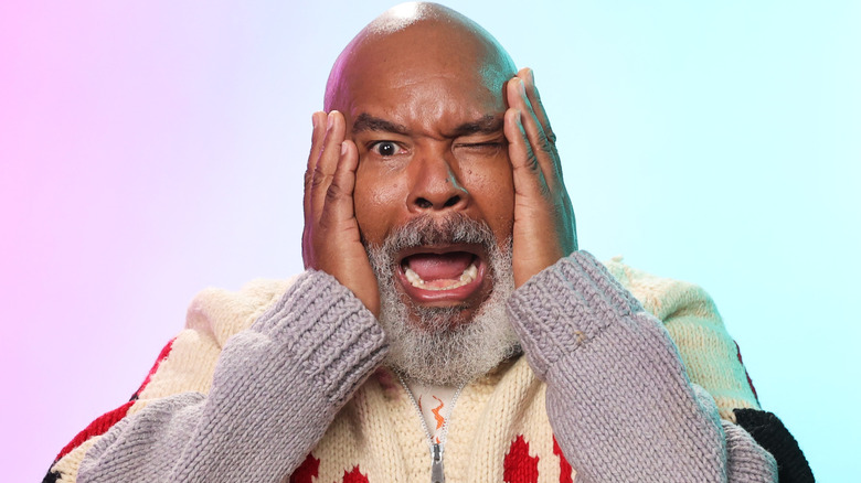 David Alan Grier holds face