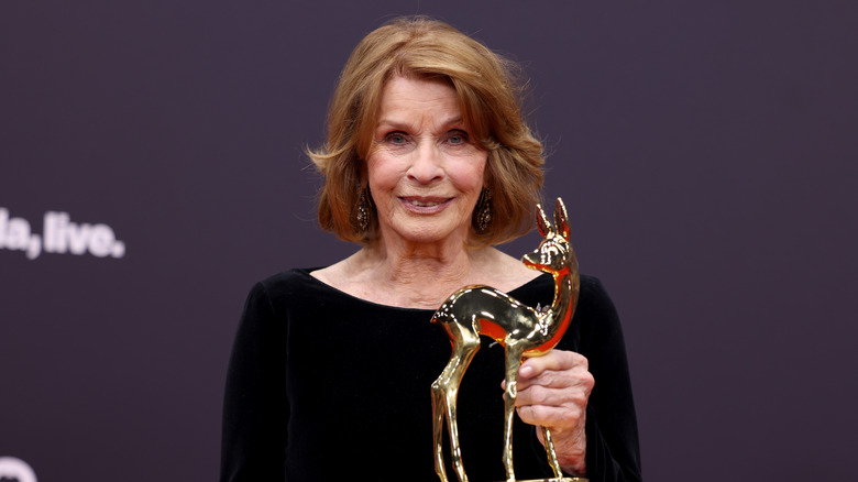 Senta Berger holding an award