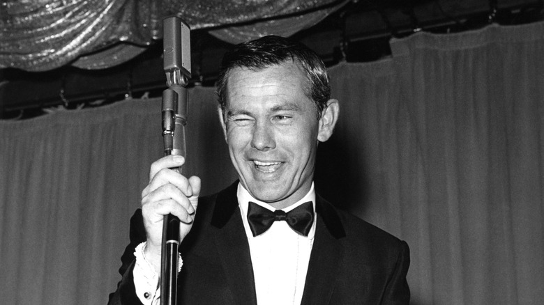 Johnny Carson performing for a crowd