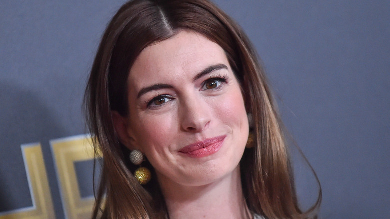 Anne Hathaway wearing gold earrings