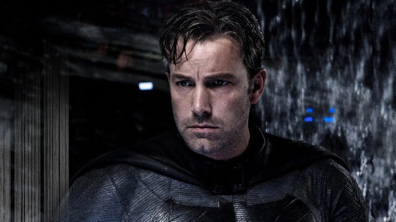 Bruce Wayne takes off his cowl and scowls