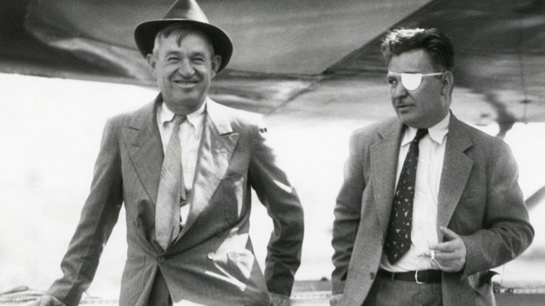 Will Rogers and Wiley Post beside an airplane