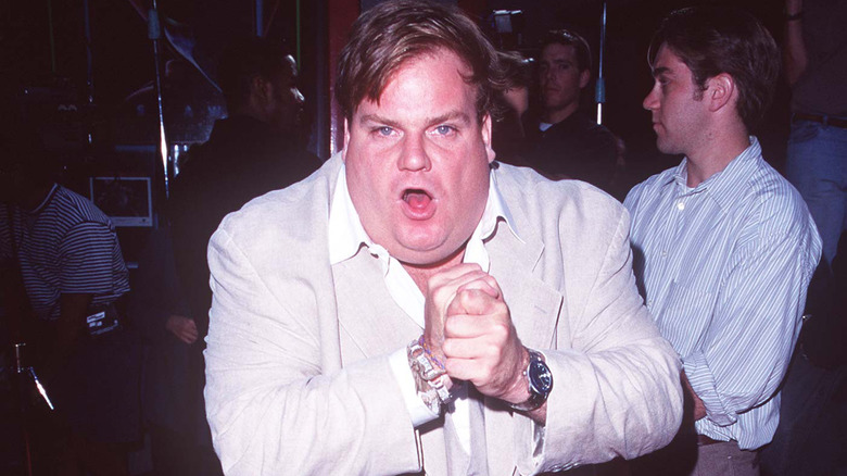 Chris Farley clasps hands together