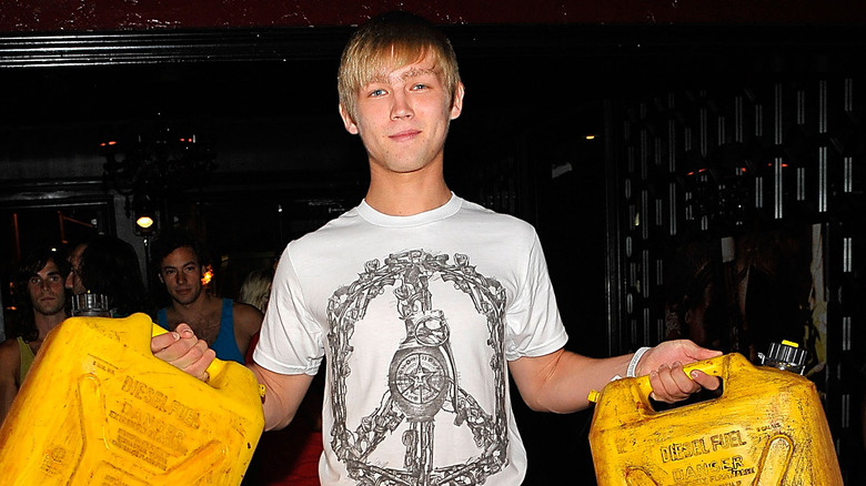 Evan Ellingson holds fuel cans