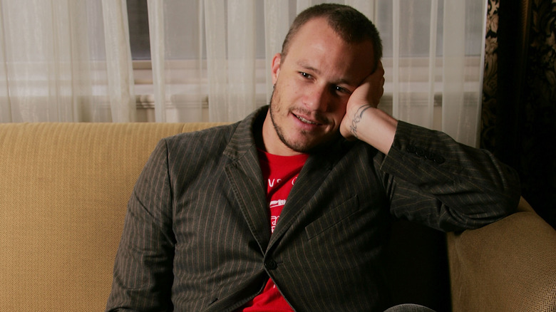 Heath Ledger sitting on couch