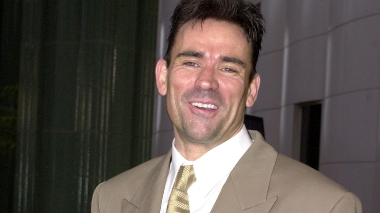 Trevor Goddard smiles in suit