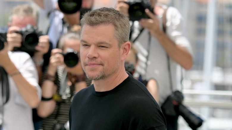 Matt Damon surrounded by photographers