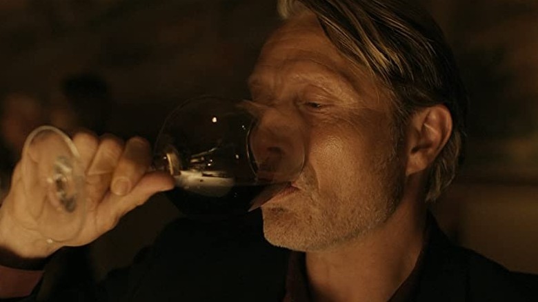 Martin drinking from wine glass