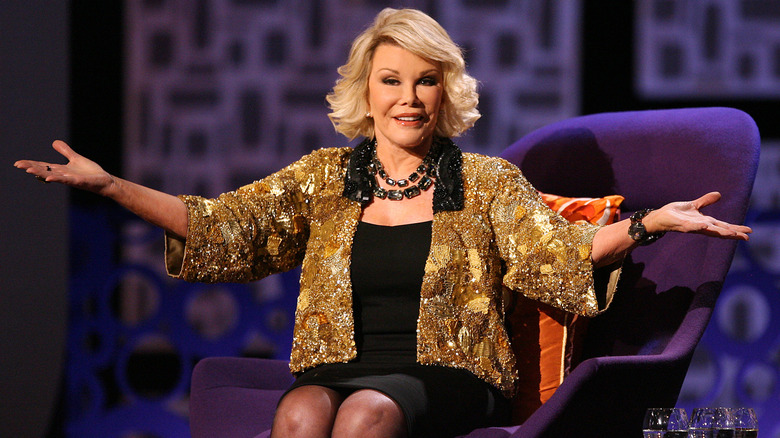 Joan Rivers in purple chair