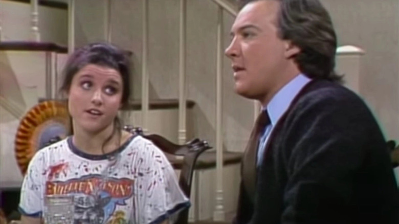 Julia Louis-Dreyfus and John Belushi performing