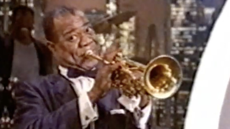 Louis Armstrong plays a trumpet